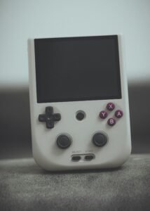 Close-up of a vintage handheld gaming console with classic design and retro buttons.