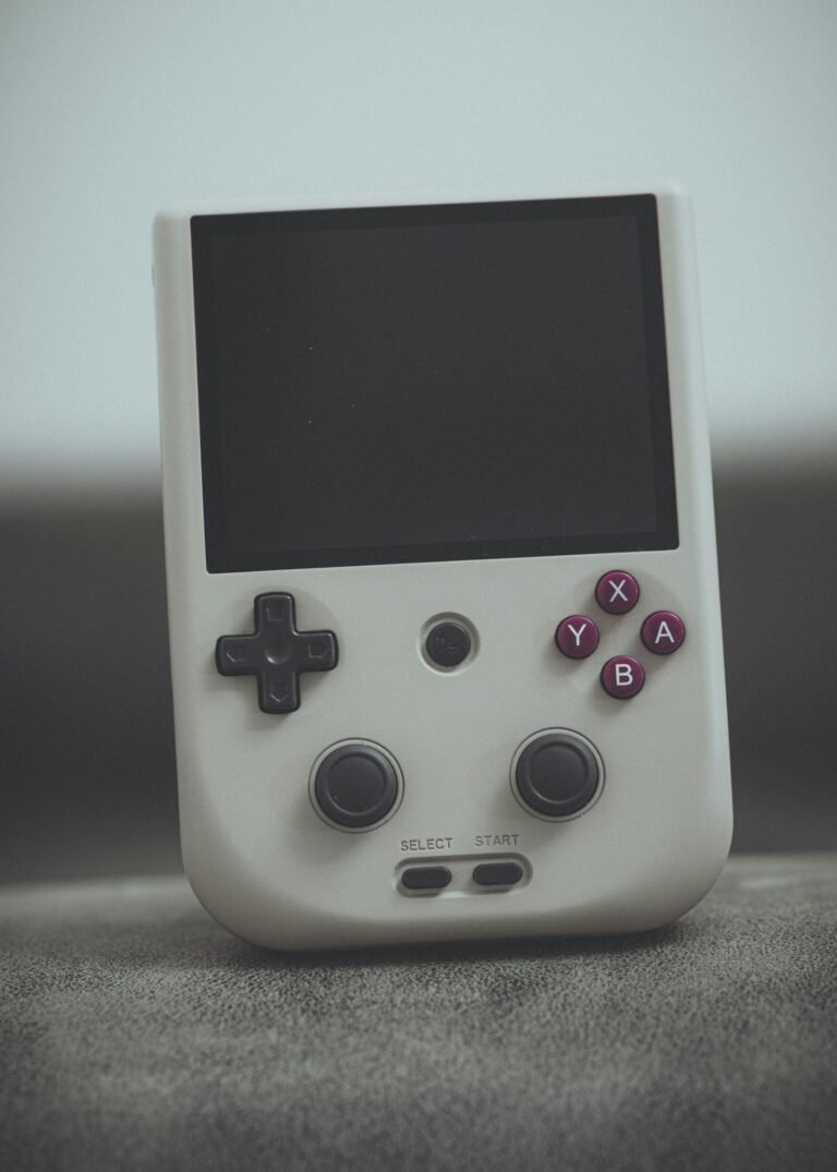 Close-up of a vintage handheld gaming console with classic design and retro buttons.